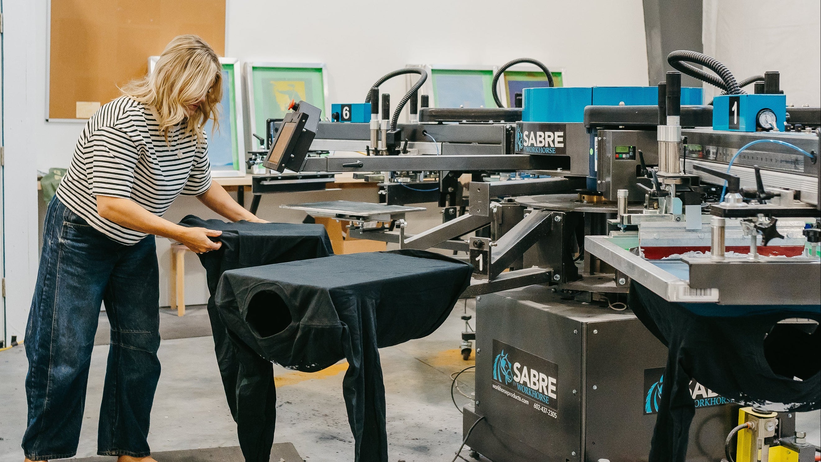 Person working with fabric in a Sabre printing facility
